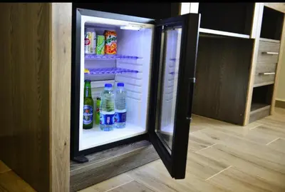 an open refrigerator filled with drinks and soda at Moses Residence in Wadi Musa