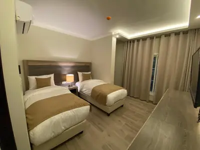 a hotel room with two beds and a window at Moses Residence in Wadi Musa