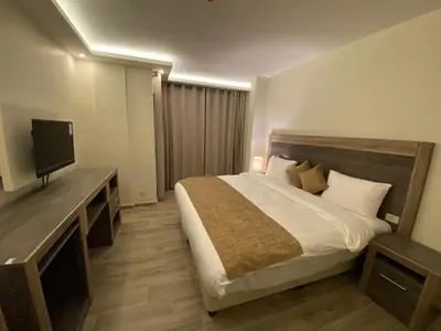 a hotel room with a bed and a television at Moses Residence in Wadi Musa