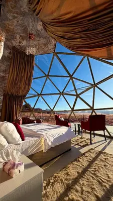 a tent with two beds in the desert at Luxury Desert & Bedouin Adventure in Wadi Rum