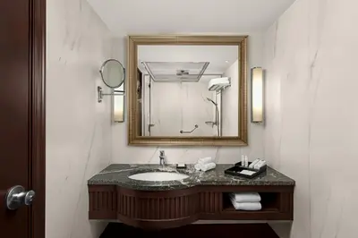 a bathroom with a sink and a mirror at Amman Marriott Hotel in Amman