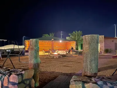 a park with a fence and a building at night at Bait Alaqaba dive center & resort in Aqaba