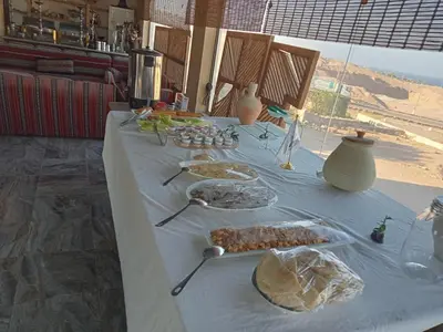 a long table with dishes of food on it at Bait Alaqaba dive center & resort in Aqaba