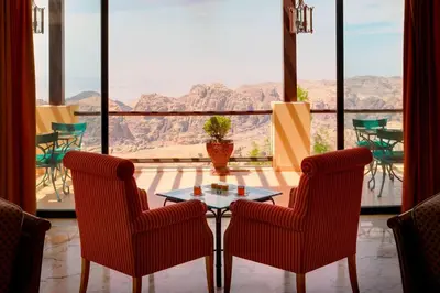 a table and two chairs in a room with a view at Petra Marriott Hotel in Wadi Musa