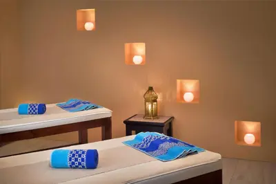 two beds in a room with lights on the wall at Petra Marriott Hotel in Wadi Musa