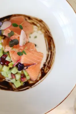 a plate of food with fish and vegetables on it at Shepherd Hotel in Amman