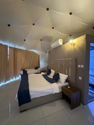 two beds in a room with a ceiling at Bubbles Desert Camp Jeep Tours in Wadi Rum
