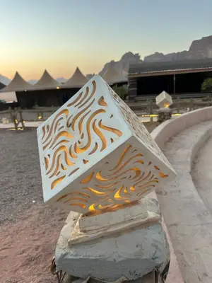 a piece of wood with flames painted on it at Bubbles Desert Camp Jeep Tours in Wadi Rum