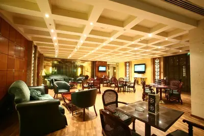 a lobby with tables and chairs and tablesktop at Le Royal Hotel - Amman in Amman