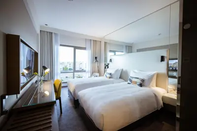 a hotel room with two beds and a window at Centro Mada Amman by Rotana in Amman