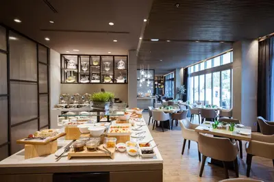 a dining room with a table with food on it at Centro Mada Amman by Rotana in Amman