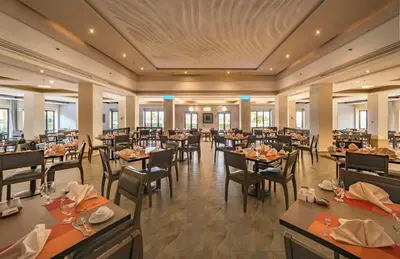a large dining room with tables and chairs at Grand Tala Bay Resort, Aqaba in Aqaba