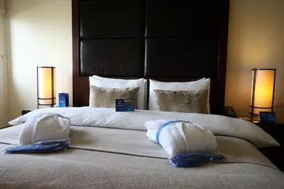 a bedroom with a large bed with two pillows at Grand Tala Bay Resort, Aqaba in Aqaba