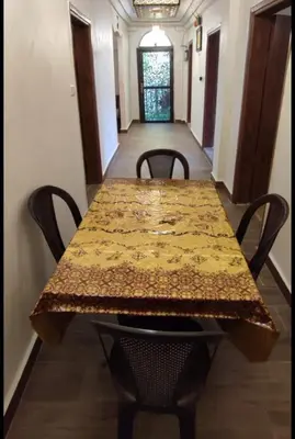 a table with chairs and a table cloth on it at the prince apartment شقة الامير in Wadi Musa