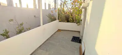 a hallway with a porch with plants on it at the prince apartment شقة الامير in Wadi Musa
