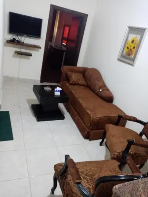 a living room with a couch and a tv at الفارس الوسيم للشقق الفندقيه in Amman