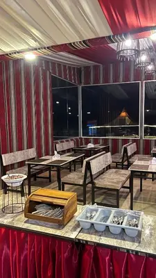 a restaurant with tables and chairs in a room at Osama Luxury Camp for Camping and Bubbles in Wadi Rum