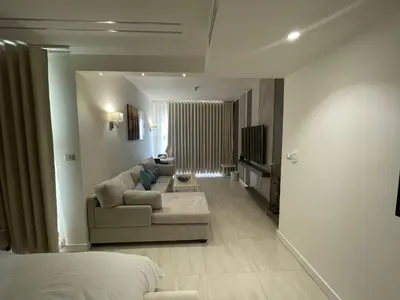 a living room with a couch and a tv in it at Porto dead sea in Sowayma