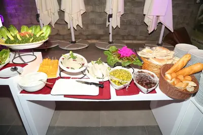 a table filled with lots of food and vegetables at Porto dead sea in Sowayma