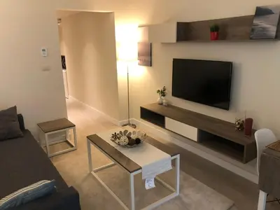 a living room with a flat screen tv on a wall at Porto dead sea in Sowayma