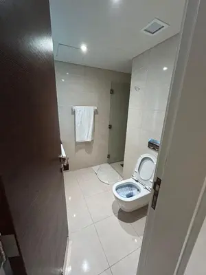 a small bathroom with a toilet and a shower at Porto dead sea in Sowayma
