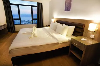 a hotel room with a bed with a large window at Baity Boutique Hotel in Aqaba