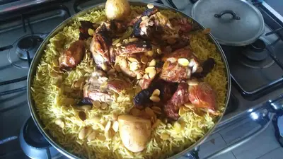 a pan of food on top of a stove at Petra Stones Inn in Wadi Musa