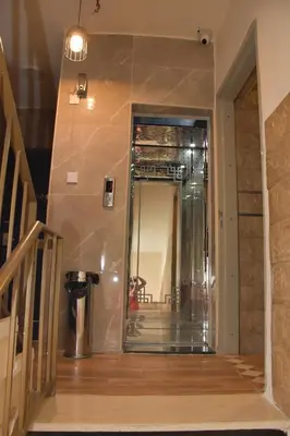 a hallway with a glass wall in a house at Al-Naher Al-Khaled Hotel in Aqaba
