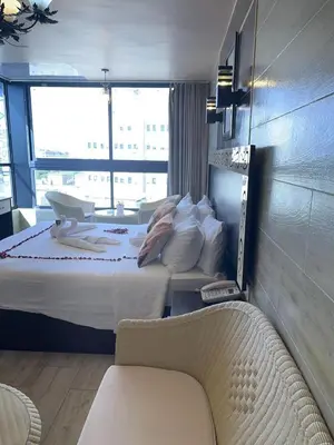 a hotel room with a bed and a chair at Al-Naher Al-Khaled Hotel in Aqaba