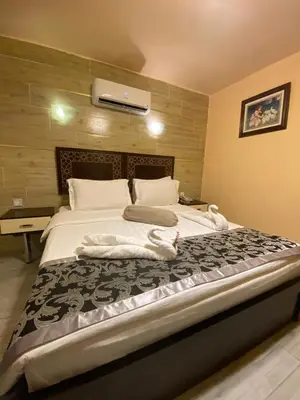 a bedroom with a large bed with towels on it at Al-Naher Al-Khaled Hotel in Aqaba