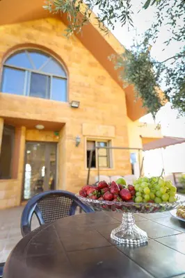 a tray of fruit on a table in front of a building at Sultana Farm - Private Pool Villa near Amman in Bayyūḑah
