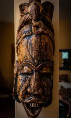 a wooden statue of a face on a wall at The Precious Villa in Sowayma