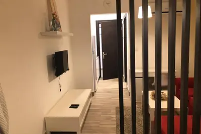 a living room with a table and a black door at My Cosy little place in Amman