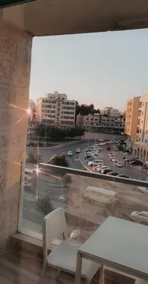 a large window with a view of a city at My Cosy little place in Amman