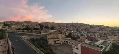 an aerial view of a city at sunset at Cleopetra Hotel in Wadi Musa