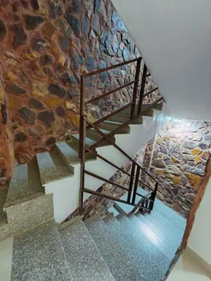 a staircase in a building with a stone wall at Cleopetra Hotel in Wadi Musa