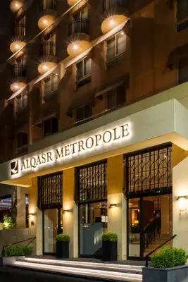 a building with a sign that reads alaskan metropole at AlQasr Metropole Hotel in Amman