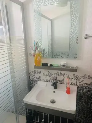a bathroom with a sink and a mirror at Eva house Lovely 3 bedrooms unit in great location in Amman for families in Amman