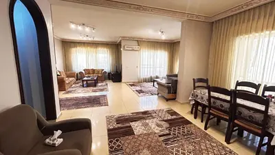 a living room with a couch and a table and chairs at Eva house Lovely 3 bedrooms unit in great location in Amman for families in Amman