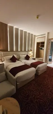 a hotel room with two beds and a couch at Lilac Hotel - Amman in Amman