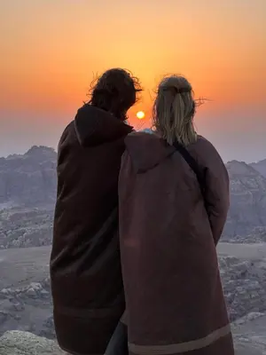 a man and a woman looking at the sunset at Petra Desert Dream Hotel in Wadi Musa