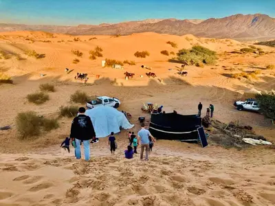 a group of people walking in the desert at Petra Desert Dream Hotel in Wadi Musa