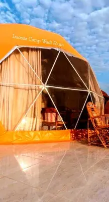 a tent with chairs and tables in it at Lukasa camp Wadi Rum in Wadi Rum