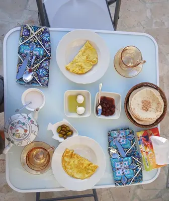a white table with plates of food on it at Celestia Boutique Inn in Jerash