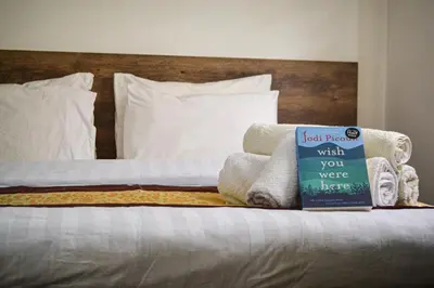 a bed with a book sitting on top of it at Hikaya studios in Wadi Musa
