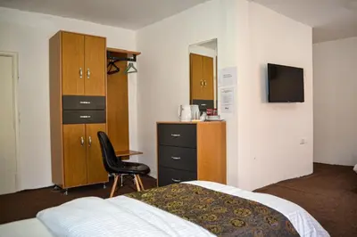 a hotel room with a bed and a chair and a desk at Hikaya studios in Wadi Musa
