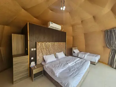 a bedroom with a large bed in a room at Rum Rayan magic camp in Wadi Rum