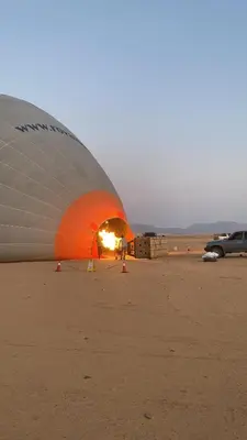 a large hot air balloon sitting in the desert at Rum Rayan magic camp in Wadi Rum