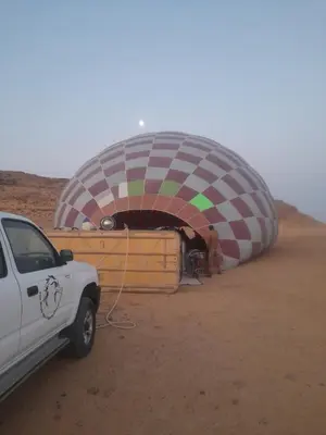 a hot air balloon being inflated in the desert at Rum Rayan magic camp in Wadi Rum