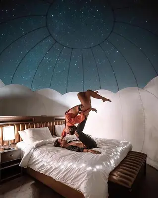 a person is doing a trick on a bed at Petra Bedouin House 1 Attallah guest house in Wadi Musa